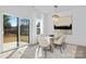Bright dining area with modern chandelier, glass table, and sliding glass doors to the backyard at 13110 Blacksmith Ct, Matthews, NC 28105
