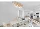 Open-concept view of the dining room with a modern chandelier and the kitchen at 13110 Blacksmith Ct, Matthews, NC 28105