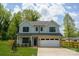 Charming two-story home with a light blue exterior, a brick-accented garage, and a well-manicured front yard at 13110 Blacksmith Ct, Matthews, NC 28105