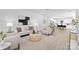 Bright living room open to kitchen and dining area with a neutral palette and modern furnishings at 13110 Blacksmith Ct, Matthews, NC 28105