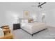 Bright main bedroom with a ceiling fan, a neutral color scheme, and access to the ensuite bathroom at 13110 Blacksmith Ct, Matthews, NC 28105