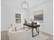 Bright home office featuring stylish lighting, a modern desk, and comfortable seating at 13110 Blacksmith Ct, Matthews, NC 28105