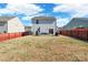 Spacious backyard featuring a well-maintained lawn, patio, and a privacy fence, perfect for outdoor gatherings at 147 Colonial Reserve Ave, Troutman, NC 28166