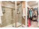 Bathroom showcasing shower with glass door and walk-in closet access at 147 Colonial Reserve Ave, Troutman, NC 28166