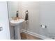 Powder room features a pedestal sink, brushed metal fixtures, and painted walls at 147 Colonial Reserve Ave, Troutman, NC 28166