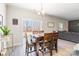 Dining area with wood table, six chairs, large window view, and flows into living area at 147 Colonial Reserve Ave, Troutman, NC 28166