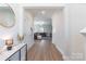 Bright entryway featuring hardwood floors, modern decor, and an open view of the living area at 147 Colonial Reserve Ave, Troutman, NC 28166