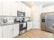 Modern kitchen features stainless steel appliances, granite countertops, and stylish white cabinetry at 147 Colonial Reserve Ave, Troutman, NC 28166