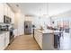 Bright kitchen features stainless steel appliances, granite countertops, and a center island with sink at 147 Colonial Reserve Ave, Troutman, NC 28166