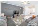 Spacious living room featuring contemporary decor, a large sectional sofa, and stylish accents at 147 Colonial Reserve Ave, Troutman, NC 28166