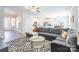Open-concept living space featuring a large sectional sofa, adjacent to the kitchen and dining area at 147 Colonial Reserve Ave, Troutman, NC 28166