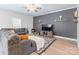 Comfortable living room with modern furnishings, ceiling fan, and plenty of natural light at 147 Colonial Reserve Ave, Troutman, NC 28166