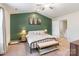 Main bedroom boasts green accent wall, ceiling fan, and coordinated decor at 147 Colonial Reserve Ave, Troutman, NC 28166