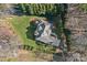 Beautiful home with manicured lawn and mature trees, as seen from an aerial perspective at 15015 Nc Hwy 73 Hwy, Huntersville, NC 28078