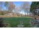 Manicured lawn and a stone path in the backyard leads to a scenic view of the lake and surrounding properties at 15015 Nc Hwy 73 Hwy, Huntersville, NC 28078