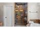 The glass enclosed shower in this bathroom features tile walls, a rainfall shower head, and built in shelving at 15015 Nc Hwy 73 Hwy, Huntersville, NC 28078