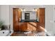 A bathroom with a dual sink vanity with black countertops and dark wood cabinets at 15015 Nc Hwy 73 Hwy, Huntersville, NC 28078