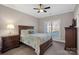 This bedroom features a wooden bed frame, wood furnishings, neutral carpet, and a large window at 15015 Nc Hwy 73 Hwy, Huntersville, NC 28078