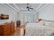 This light and airy bedroom features a tray ceiling, wood floors, and a sunny bay window with shutters at 15015 Nc Hwy 73 Hwy, Huntersville, NC 28078