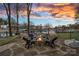 Cozy stone fire pit area with seating, perfect for enjoying evenings by the lake with amazing views at 15015 Nc Hwy 73 Hwy, Huntersville, NC 28078