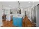 Open-concept kitchen with white cabinetry, marble countertops, and blue island at 15015 Nc Hwy 73 Hwy, Huntersville, NC 28078