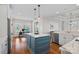 Bright kitchen features a marble countertops and blue island at 15015 Nc Hwy 73 Hwy, Huntersville, NC 28078