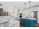 Bright kitchen features a marble countertops and blue island at 15015 Nc Hwy 73 Hwy, Huntersville, NC 28078