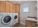 Well-equipped laundry room with cabinets, sink, and washer/dryer at 15015 Nc Hwy 73 Hwy, Huntersville, NC 28078