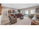 This living room has a full bar, comfortable seating, neutral paint, and sliding doors to the yard at 15015 Nc Hwy 73 Hwy, Huntersville, NC 28078
