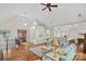 Bright living room featuring hardwood floors, vaulted ceiling, and an open layout to the kitchen at 15015 Nc Hwy 73 Hwy, Huntersville, NC 28078