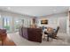 Living room boasts neutral walls, sliding doors to the yard, comfortable furniture, and a television at 15015 Nc Hwy 73 Hwy, Huntersville, NC 28078
