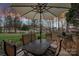 Outdoor patio set with an umbrella offering a great spot to enjoy outdoor living and serene backyard views at 15015 Nc Hwy 73 Hwy, Huntersville, NC 28078