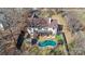 Aerial view of backyard with a large pool, two-story deck, and mature trees at 153 Byers Rd, Troutman, NC 28166