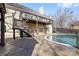 Two-story deck overlooking a pool and patio area with a swing and lounge chair at 153 Byers Rd, Troutman, NC 28166