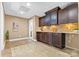 Basement with kitchenette, custom cabinets, tile backsplash, and tile floor at 153 Byers Rd, Troutman, NC 28166