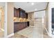 Finished basement with a bar area featuring rich cabinetry, mosaic backsplash, and tile floors at 153 Byers Rd, Troutman, NC 28166