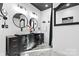 Modern bathroom featuring double sink vanity with black cabinetry and round mirrors at 153 Byers Rd, Troutman, NC 28166