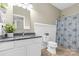 Well-lit bathroom featuring a granite countertop, toilet and shower with floral curtain at 153 Byers Rd, Troutman, NC 28166