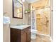 Bathroom with granite vanity, decorative mirror, and a unique stone tile shower at 153 Byers Rd, Troutman, NC 28166