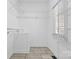 Walk-in closet featuring wire shelving, wood-look tiled flooring, and a window at 153 Byers Rd, Troutman, NC 28166