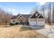 Charming ranch-style home featuring a two-car garage, covered porch, and well-manicured landscaping at 153 Byers Rd, Troutman, NC 28166
