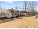 Ranch home with a well-maintained lawn and a two-car garage surrounded by mature trees at 153 Byers Rd, Troutman, NC 28166