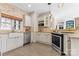 Charming kitchen with stainless steel appliances, a farmhouse sink, and granite countertops at 153 Byers Rd, Troutman, NC 28166