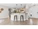 Well-lit open kitchen featuring modern white cabinets, stainless steel appliances, and bar seating at 153 Byers Rd, Troutman, NC 28166