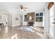 Cozy living room featuring a stone fireplace, light hardwood floors, and built-in shelves at 153 Byers Rd, Troutman, NC 28166
