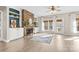 Bright living room with a stone fireplace, built-in shelving, light floors, and large windows at 153 Byers Rd, Troutman, NC 28166