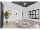 Main bedroom boasts tray ceiling, black window trim, tile flooring, and stylish decor at 153 Byers Rd, Troutman, NC 28166