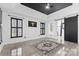 Spacious main bedroom with sliding barn door, statement ceiling, two windows and tile floor at 153 Byers Rd, Troutman, NC 28166