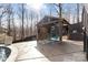 Poolside cabana featuring blue Adirondack chairs on a concrete patio with a privacy screen at 153 Byers Rd, Troutman, NC 28166
