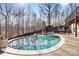 Backyard pool with a cabana and a wooden fence surrounded by mature trees creating a private backyard retreat at 153 Byers Rd, Troutman, NC 28166